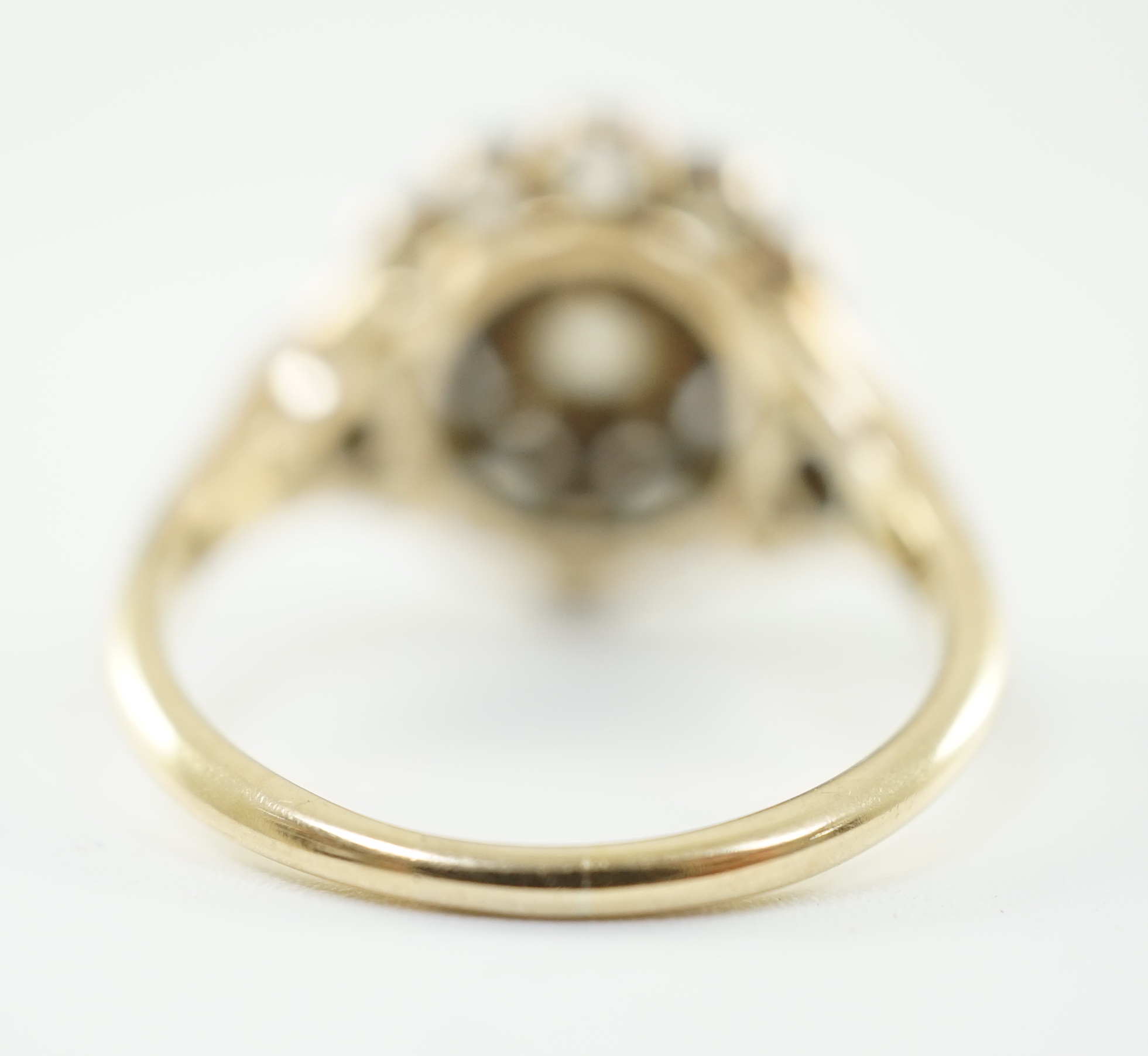 A mid 20th century gold and millegrain set diamond cluster target ring